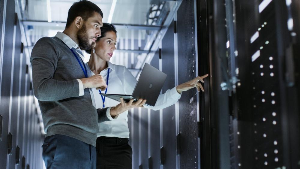 Two professionals evaluating a mainframe computer