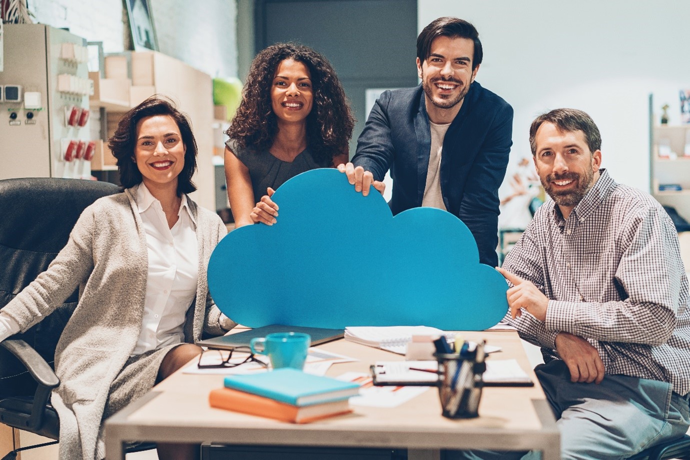 Office with people behind a cut out cloud
